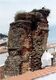 Foto antigua de la torre de las Harinas en la que se aprecian los restos de los listeles almohades que la coronaron y la huella del inteste del muro